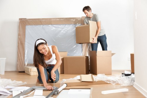Removal team planning a flat move in Colliers Wood with boxes and furniture