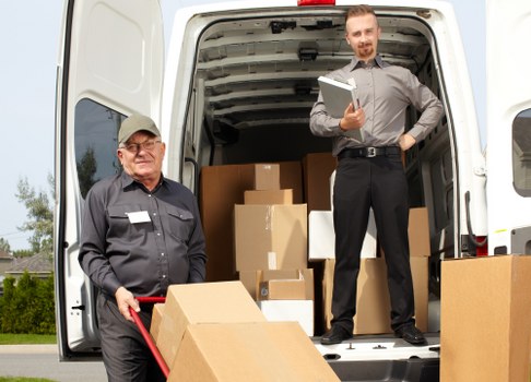 Moving van and packed boxes representing transparent pricing for Colliers Wood removals