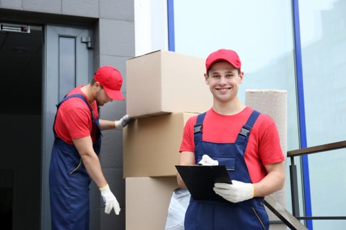Moving team loading household items into a removals vehicle