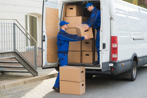 Removal professionals handling furniture in a property hallway