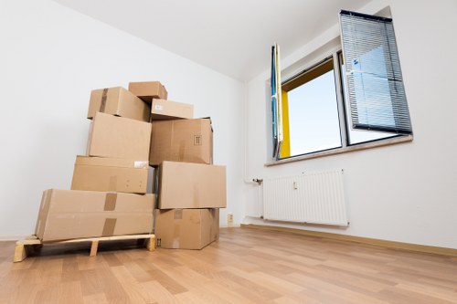 Piano movers navigating a narrow staircase in a Colliers Wood property