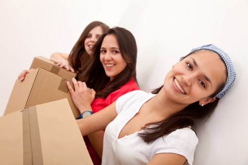 A moving crew organizing items at a new property in Colliers Wood
